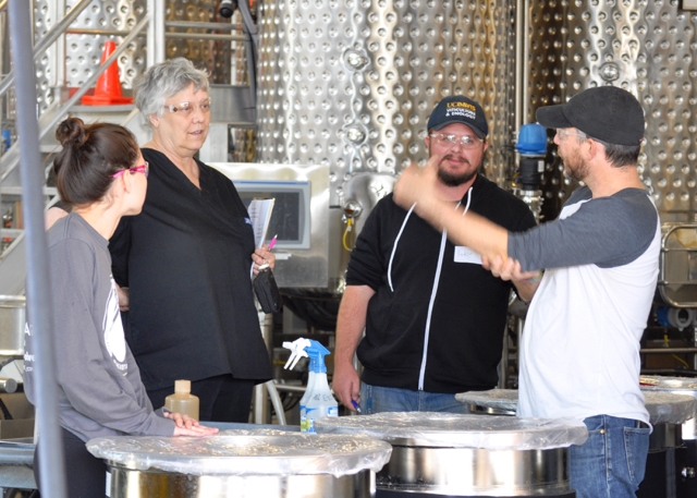 Dr. Hildegarde Heymann, second from left, consults with students in the Winemaking lab class.