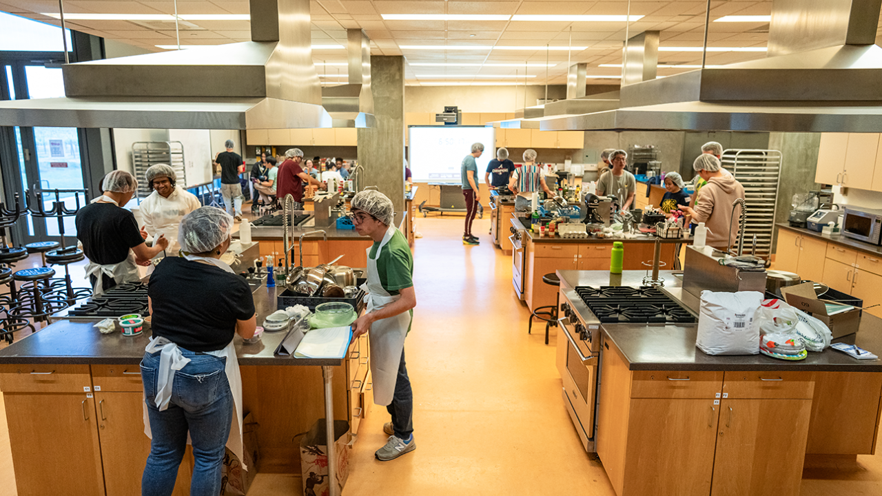 UC Davis students participating in the Upcycled Iron Chef Competition in the student kitchen.