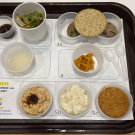 Tray filled with sample food items in small plastic cups