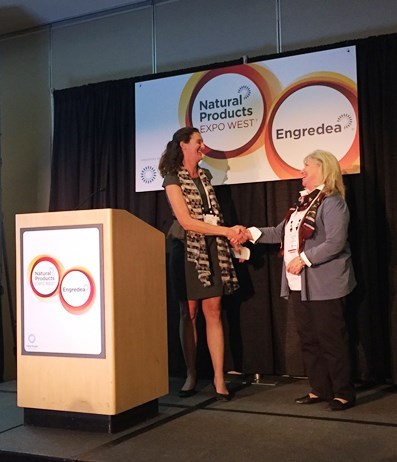UCD Director of Development Melissa Haworth accepts the gift from SCIFTS, given by Katie Feicht