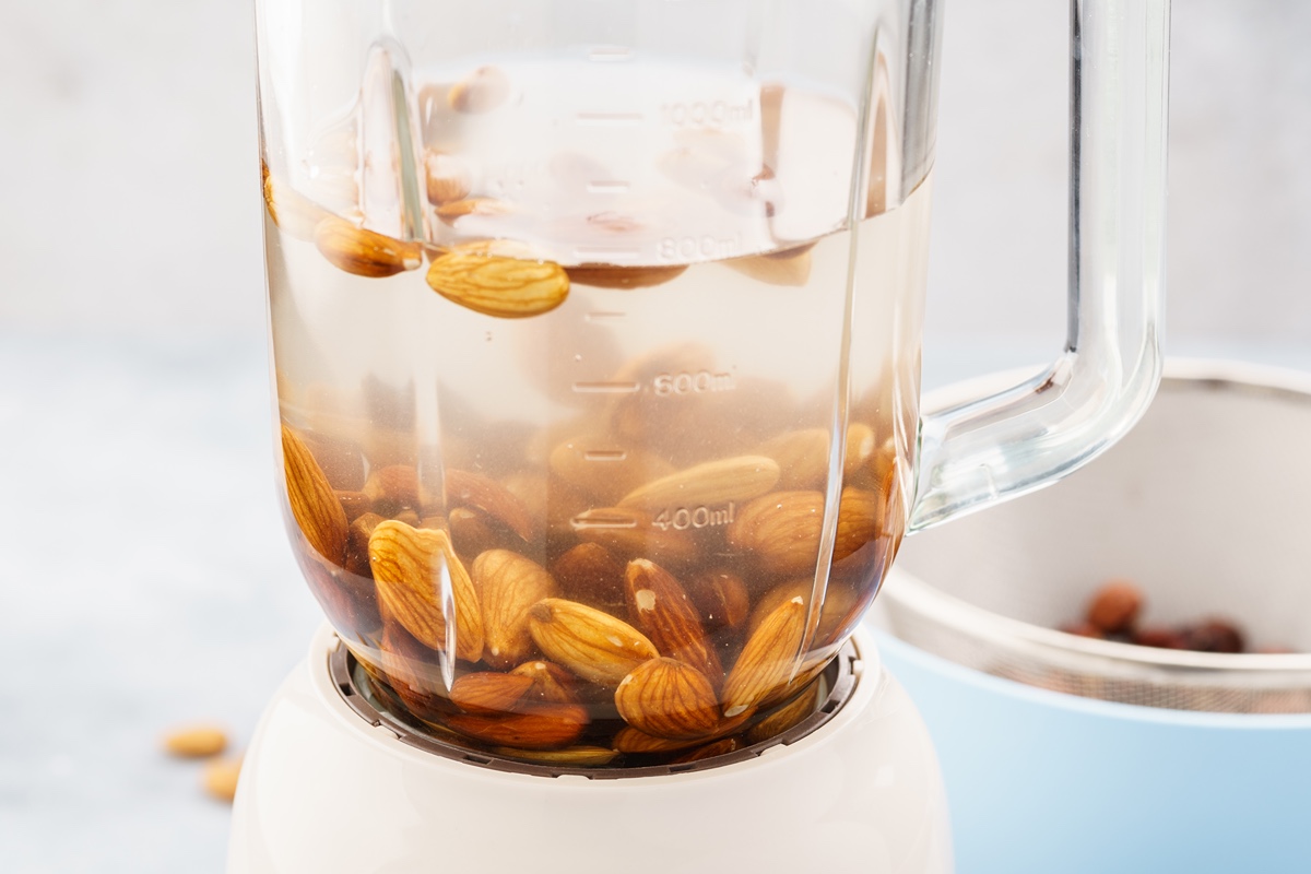 Almonds soak in water in a blender. 