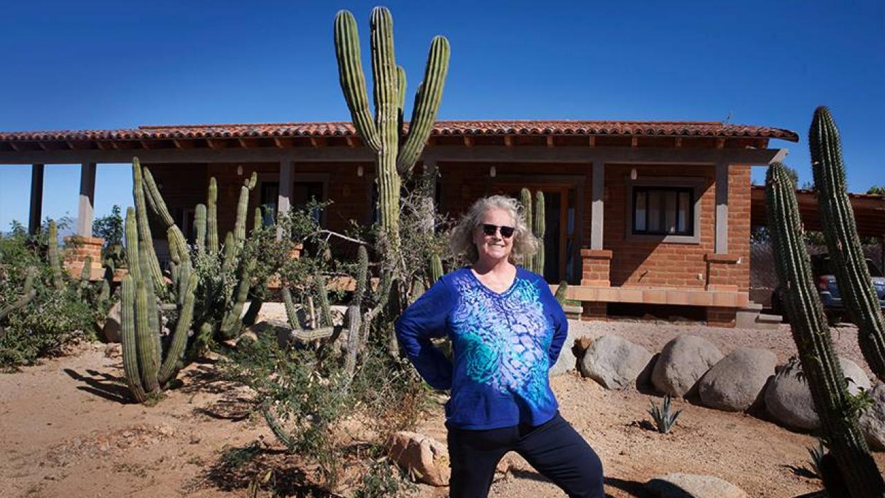 Margaret in front of her Baja Sur home & desert sanctuary, 2019 Margaret and her house