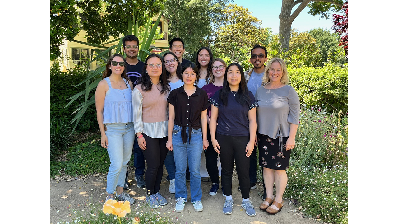 The eleven members of Marco lab posing together outdoors.