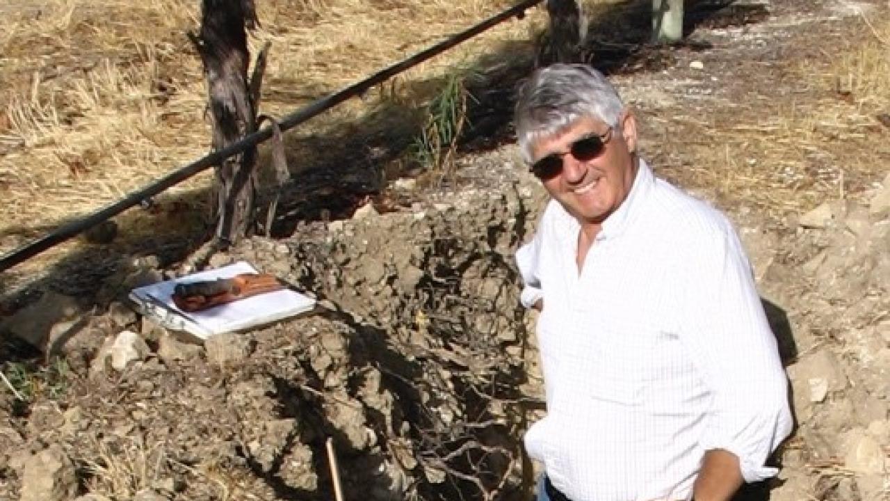 Dr. Lambert surrounded by viticulture soil Dr. Lambert in the soil