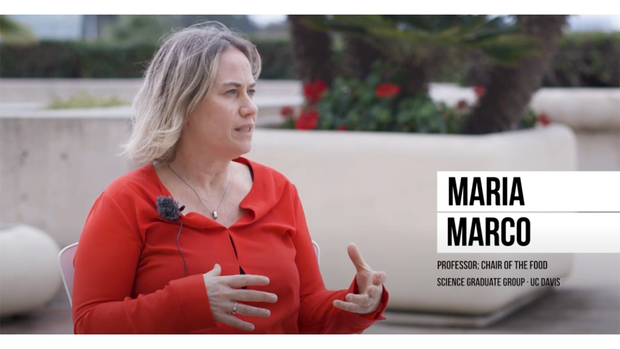 Maria Marco sitting and discussing her research in an interview.