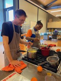 Two people happily cooking dinner.