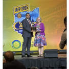 Linda Harris receiving a plaque with her IAFP Honorary Life Membership Award