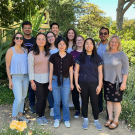 The eleven members of Marco lab posing together outdoors.