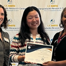 Poll Zhang is presented with an award plaque.