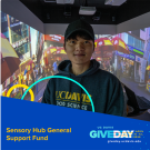 Sensory Hub Support Fund - student in front of Sensory Room screen
